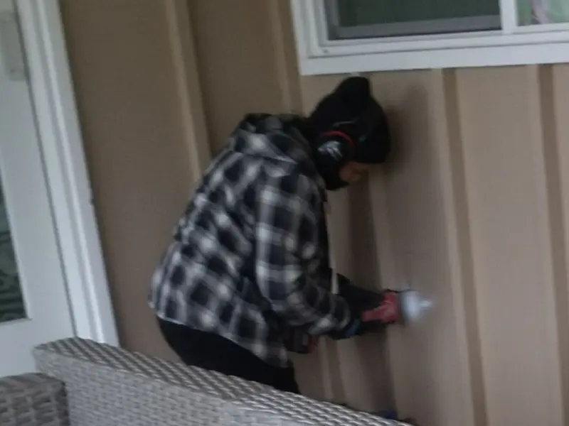 Professional electrician installing an exterior outlet in Farmerville
